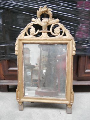 un miroir posé par terre devant une armoire