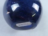an image of a blue glass ball with a sticker on it