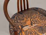 a wooden chair with a floral design on the seat