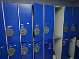 several blue lockers are lined up in a row in a room
