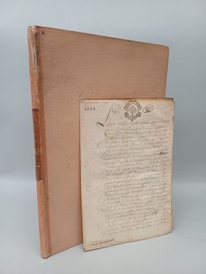 an old book with a piece of paper on top of it