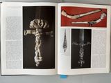an open book with a picture of a cross on it