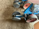 a small blue machine that is sitting on the floor