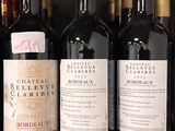 several bottles of wine are lined up on a shelf in a store
