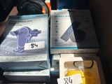 many boxes of electronics sitting on a table in a room