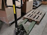 a fork lifter sitting on a pallet in a warehouse