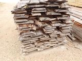 a pile of wood sitting on the ground in the dirt