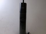 a close up of a vacuum cleaner on a table next to a lamp