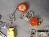 many different key chains and keyrings that are on a table