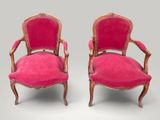 two pink chairs with gold trim and a red upholstered seat