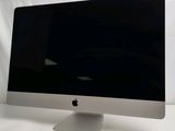 a computer monitor sitting on top of a white table