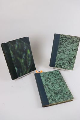 three books are sitting on a white surface, one is green and the other is blue