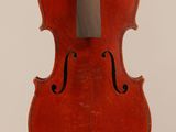 an old violin sitting on top of a white surface