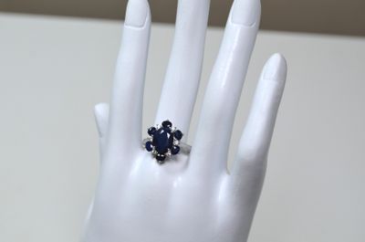 Une bague en argent, sertie au centre d'un saphir facetté ov…