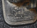 a close up of a silver plate with a dog on it