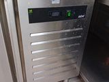a stainless steel oven in the corner of a kitchen