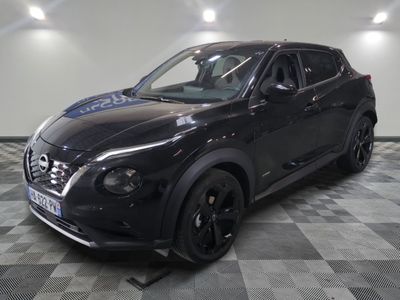 the black nissan juke suv is parked in a showroom