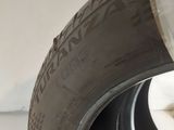 the tire of a white car with a black rim and a white wheel