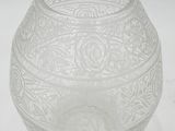 a clear glass vase with a design on it