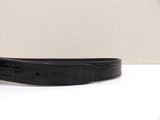 a close up of a black belt on a white surface
