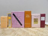 five boxes of perfume sitting on a table next to each other