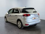 the rear end of a silver citrole parked in a room