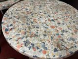 a marble table and two chairs in a room