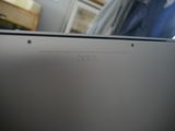 a close up picture of a laptop computer with a person standing in the background