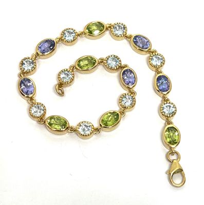 Bracelet souple en argent doré serti de tanzanites, péridots…