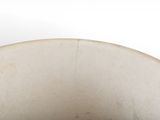 a white bowl with a brown lid sitting on a table