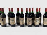 six bottles of wine are lined up in a row on a white surface