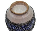 a blue and white vase sitting on a white surface