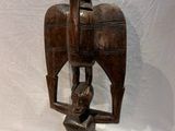 statue of a man holding a bird on his back
