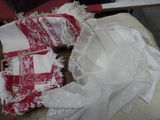 a pile of white and red cloths on a table