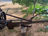 a tractor with a plow attached to it in a field