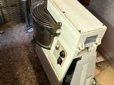 a white machine that is sitting on the floor
