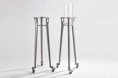 two tall candles that are sitting on a table