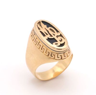 an image of a gold signet ring with a black and white design