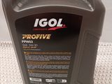 a close up of a bottle of engine oil on a table