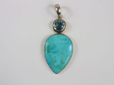a pendant with a turquoise stone and a blue topaze stone