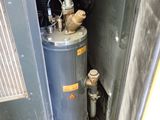 a water heater in the corner of a room