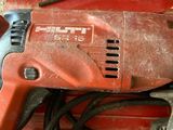a drill that is sitting on top of a red box