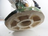 a figurine of an owl sitting on top of a vase
