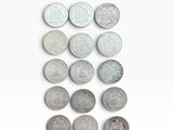 several different coins are arranged in a row on a white surface