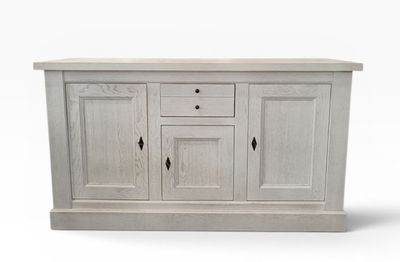 a white wooden sideboard with two drawers and two doors