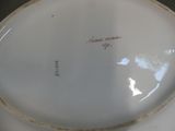 a white plate with writing on it sitting on a table
