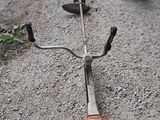 a small lawn mower that is laying on the ground