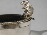 a silver box with a rat on top of it