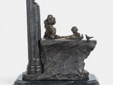 statue of a boy and a dog sitting on a rock with a fountain
