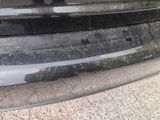 a close up of a car ' s bumper with scratches on it